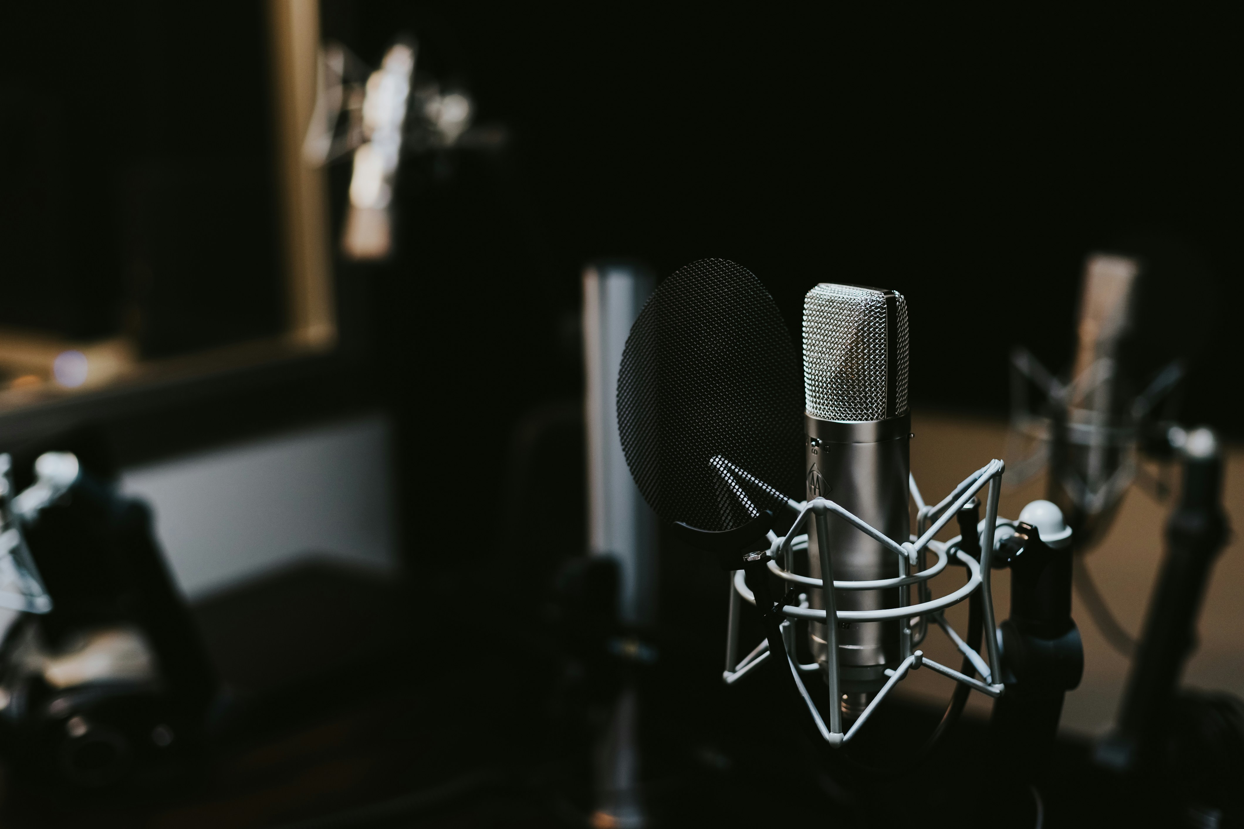 Studio-grade microphone in a sound booth for high-quality podcast audio recording