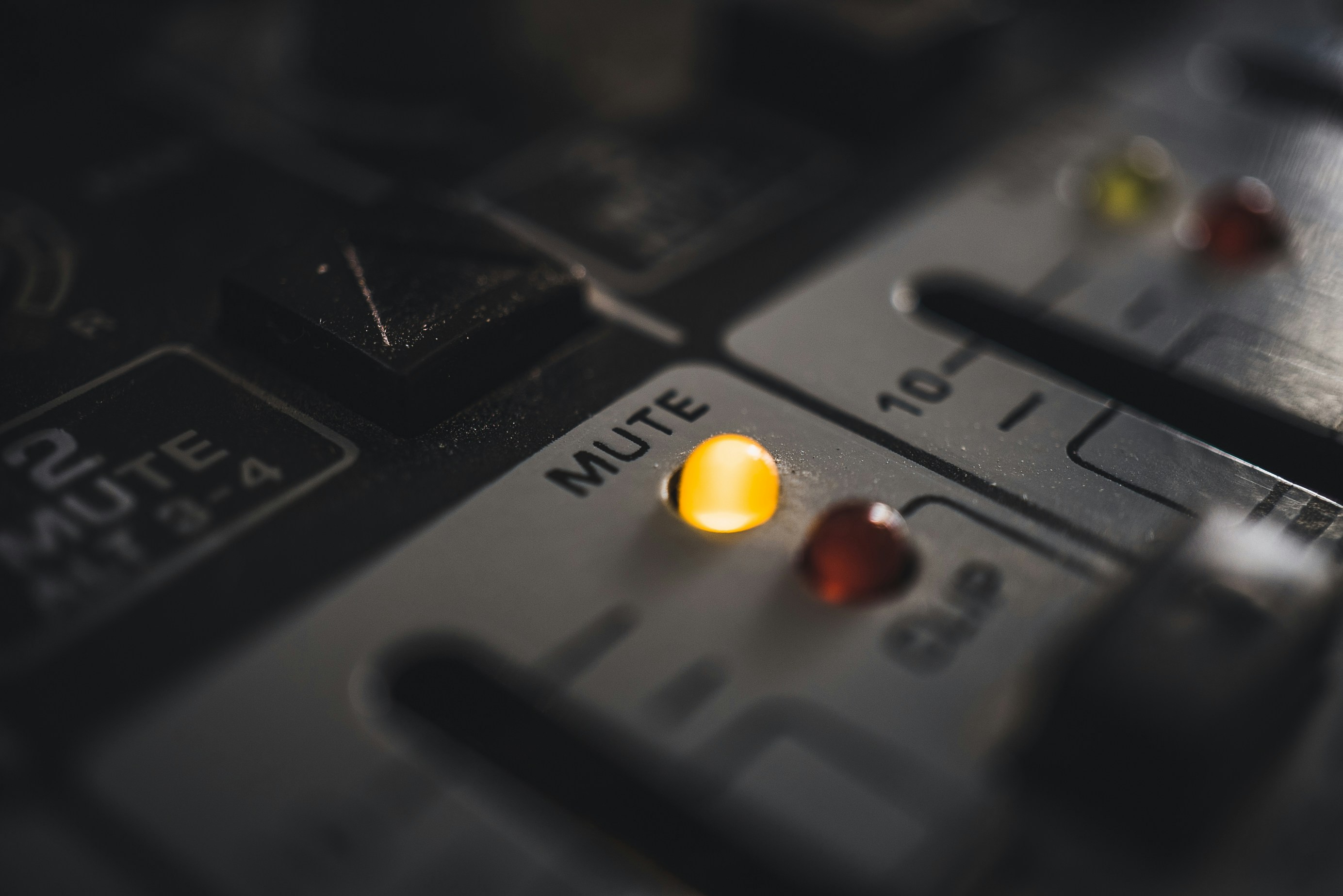 Close-up of professional audio mixer controls, essential for podcast production