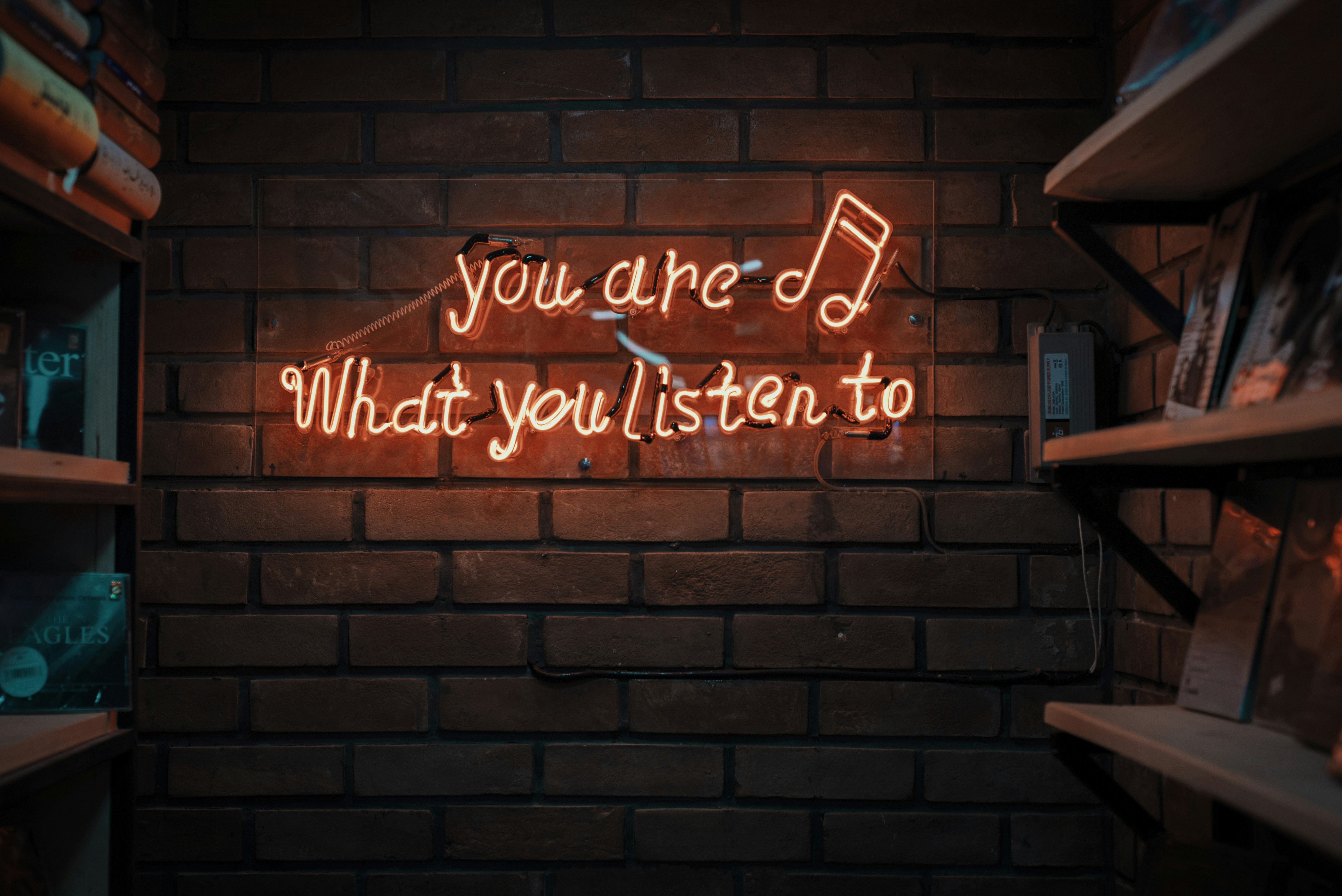 Neon sign reading You are what you listen to, ideal podcast studio decor