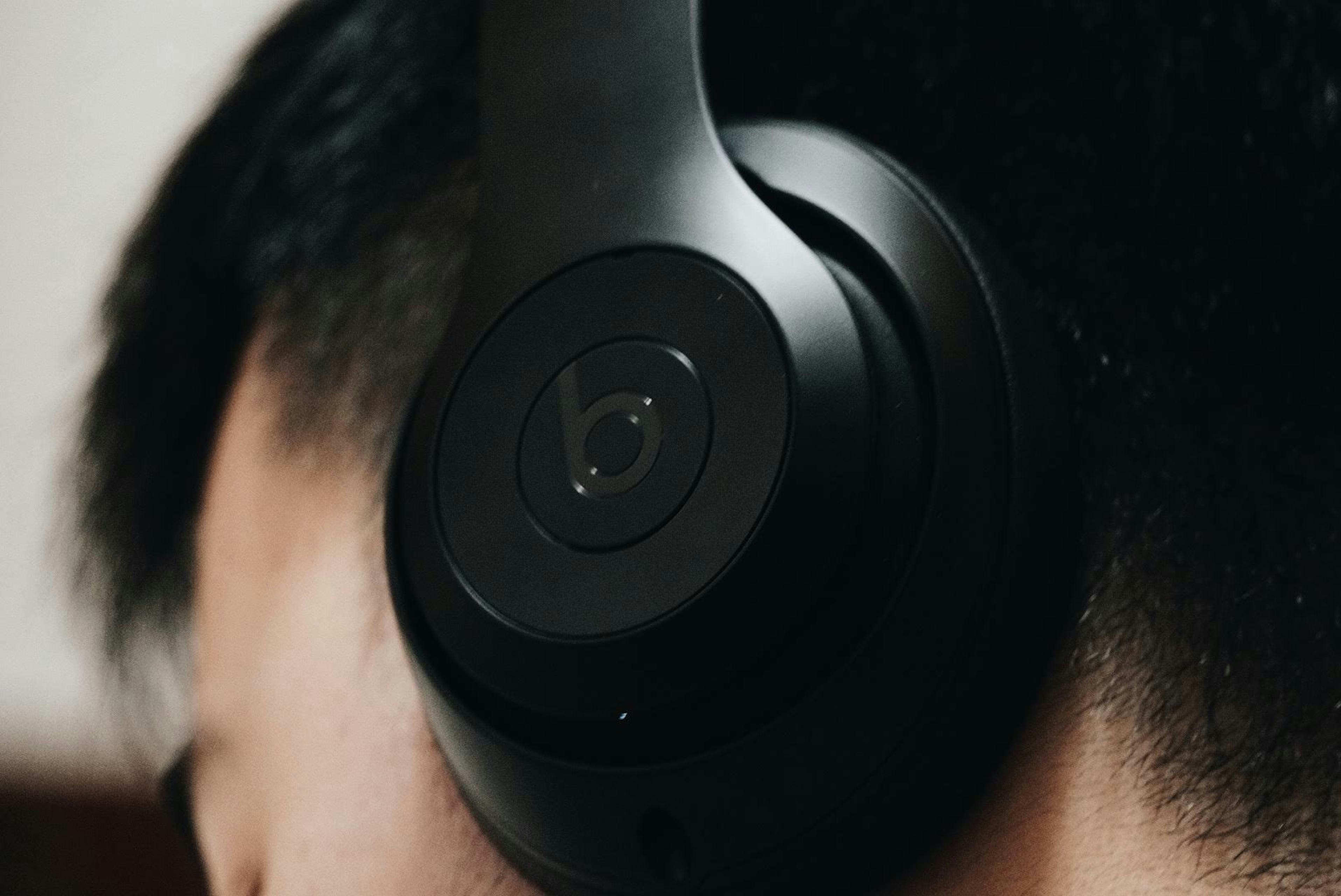 Close-up of modern headphones worn by a podcast listener