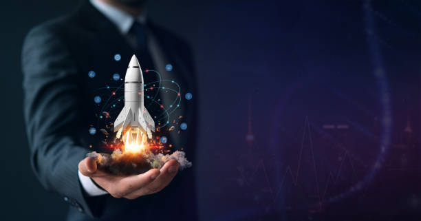 Businessman holding a launching rocket, startup innovation concept