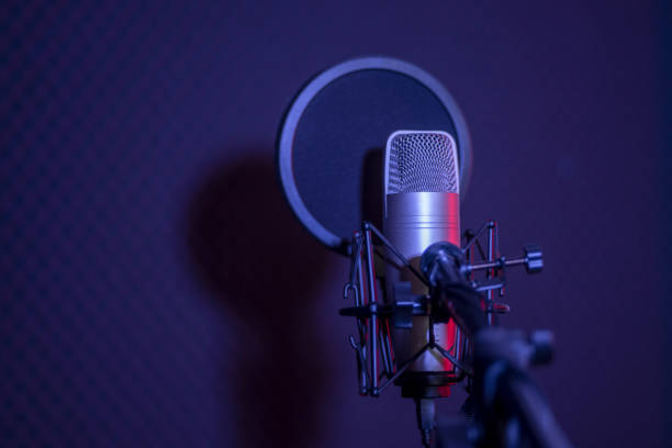 Studio condenser microphone with ring light on a purple backdrop